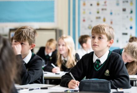A bright young student in a classroom