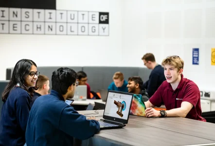 Students working on laptops in the common room