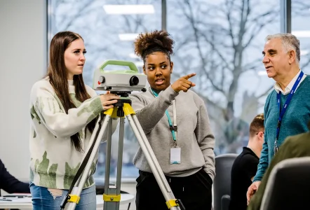 Construction students using a laser level
