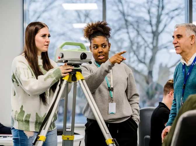 Construction students using a laser level