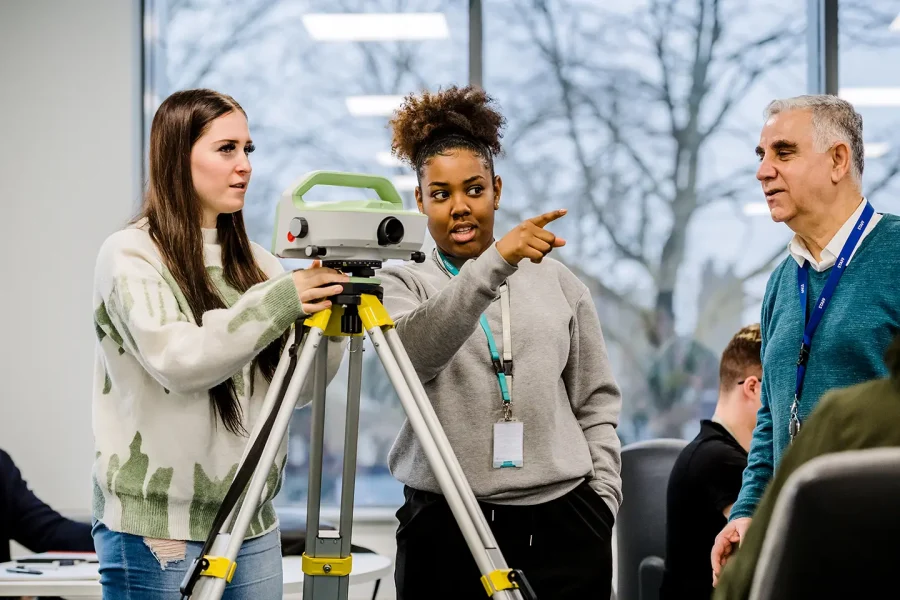 Construction students using a laser level