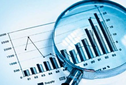 A magnifying glass inspecting a graph