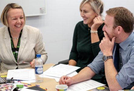 Three teachers discussing matters in a meeting