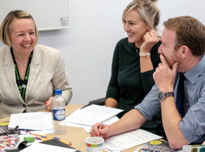 Three teachers discussing matters in a meeting
