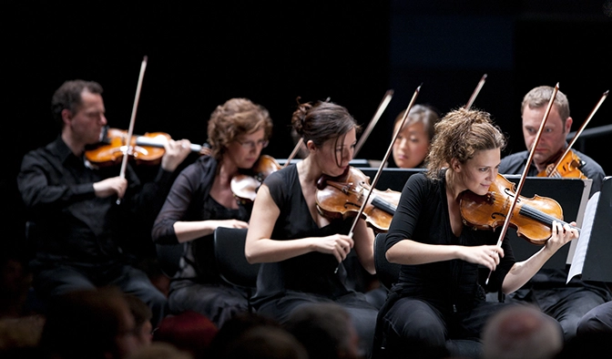 Violinists playing in orchestra