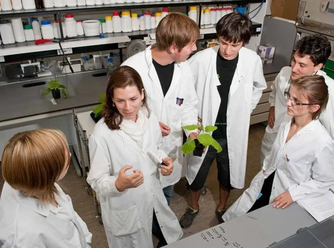 Plant science teacher and students in laboratory