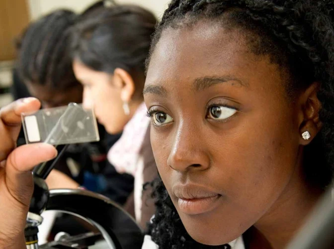 A female student inspecting samples in plant science class