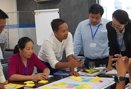 Colleagues discussing ideas at a workshop
