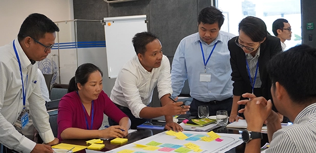 Colleagues discussing ideas at a workshop